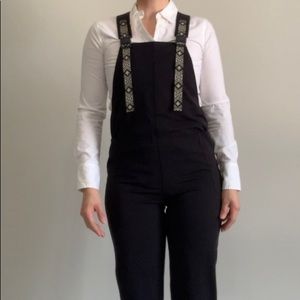 Womens black XXS Kavu overalls with black and white designs on straps